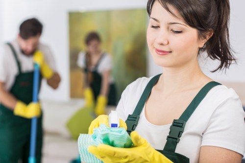 Cleaner wearing protective gloves and mask during carpet treatment